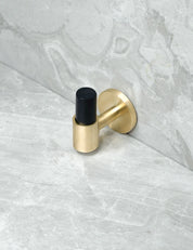 SIGNATURE 30 END knob in Brushed Brass/Black Horn. Luxury cabinet hardware made of solid brass by BRANDT Collective.