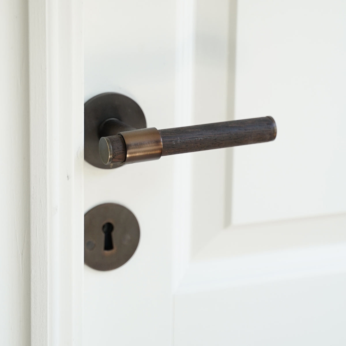 BRANDT Collective THE END door handle in burnished brass and wenge