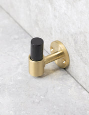 SIGNATURE hook in Brushed Brass/Black Horn. Luxury hardware made of solid brass by BRANDT Collective.