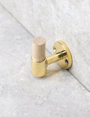 SIGNATURE hook in Polished Brass/Oak. Luxury hardware made of solid brass by BRANDT Collective.