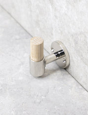 SIGNATURE hook in Polished Nickel/Oak. Luxury hardware made of solid brass by BRANDT Collective.