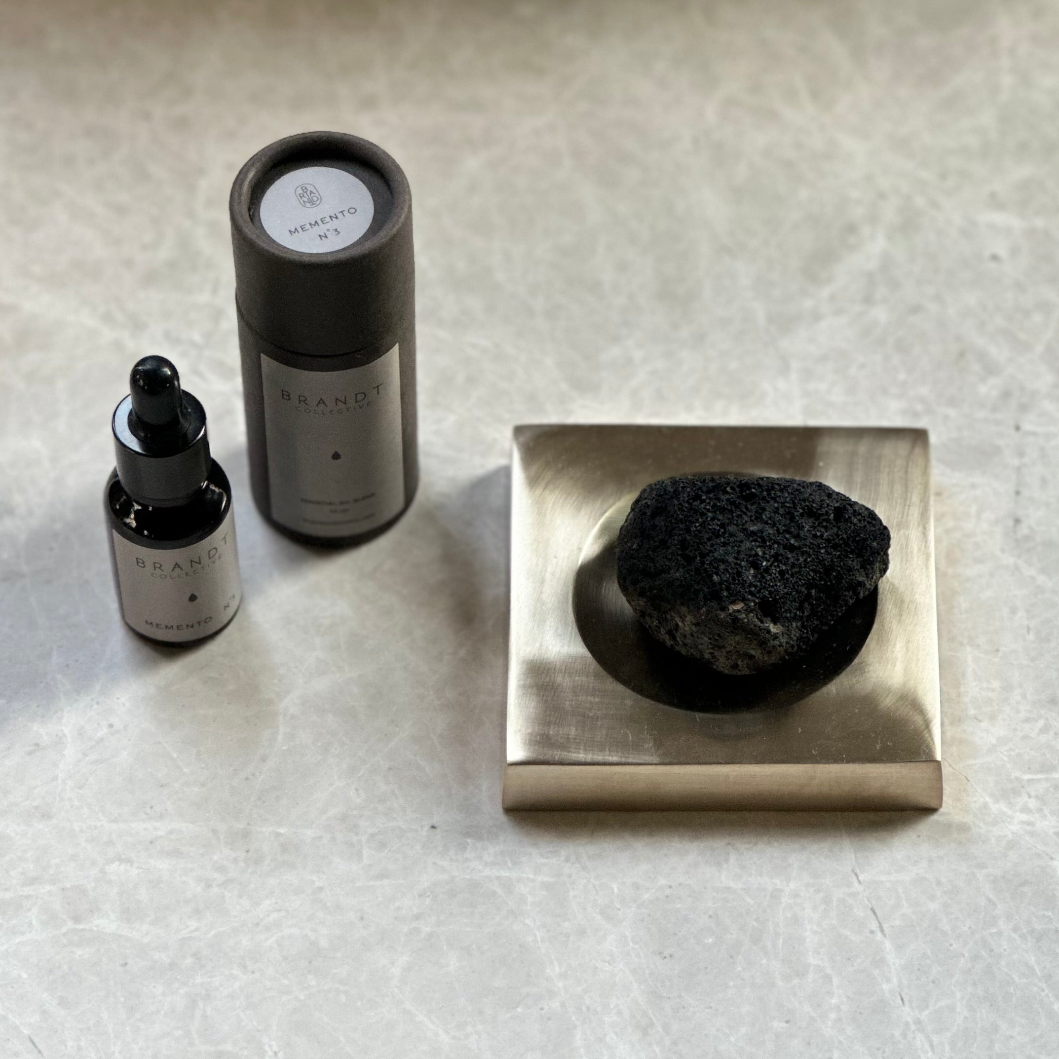 PLATEAU fragrance tray set in Satin Brass, lava rock and oil. Designed by Julie Brandt for BRANDT Collective