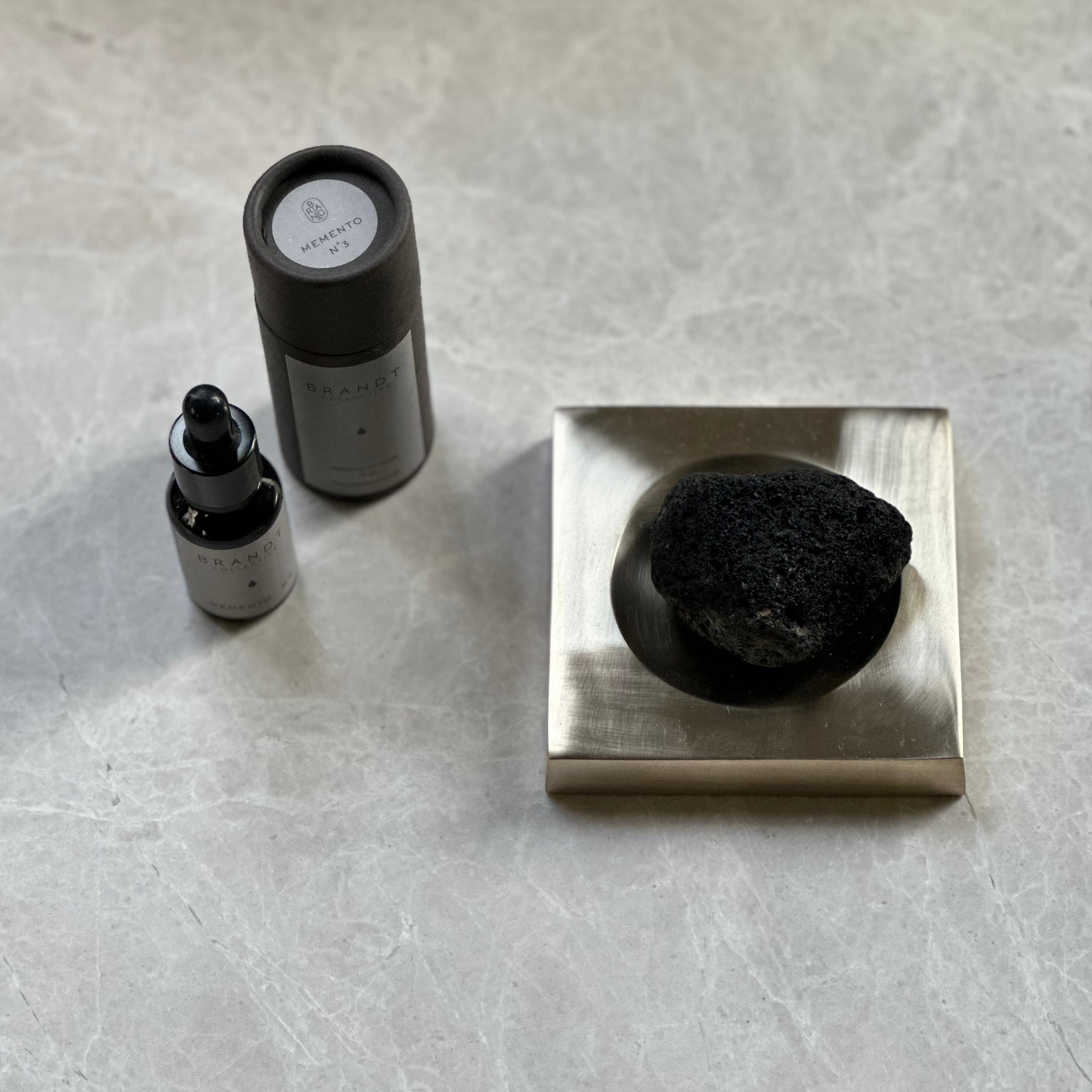 PLATEAU fragrance tray set in Satin Brass, lava rock and oil. Designed by Julie Brandt for BRANDT Collective