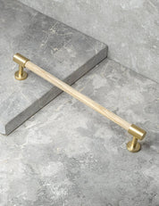 REFINED END pull bar 186 mm in Brushed Brass/Oak. Modern cabinet hardware made of solid brass by BRANDT Collective.