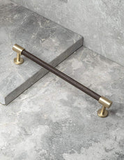 REFINED END pull bar 186 mm in Brushed Brass/Wenge. Modern cabinet hardware made of solid brass by BRANDT Collective.