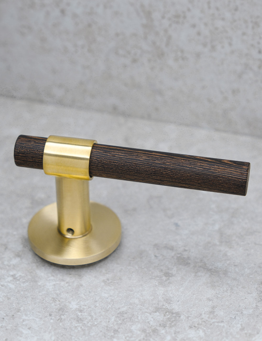 SIGNATURE door handle in Brushed Brass/Wenge. Modern door hardware made of solid brass by BRANDT Collective.