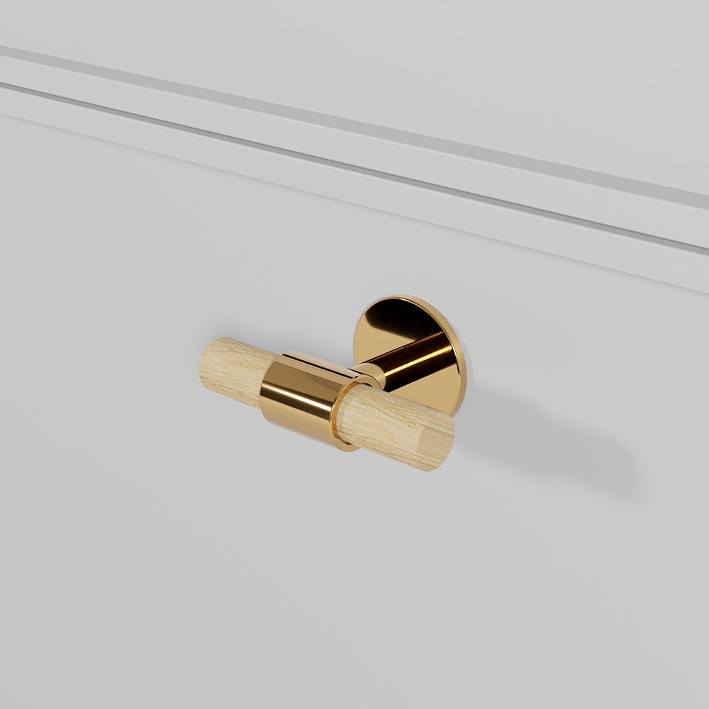 SIGNATURE 30 T-bar handle 60 mm in Polished Brass/Oak. Luxury kitchen hardware made of solid brass by BRANDT Collective.