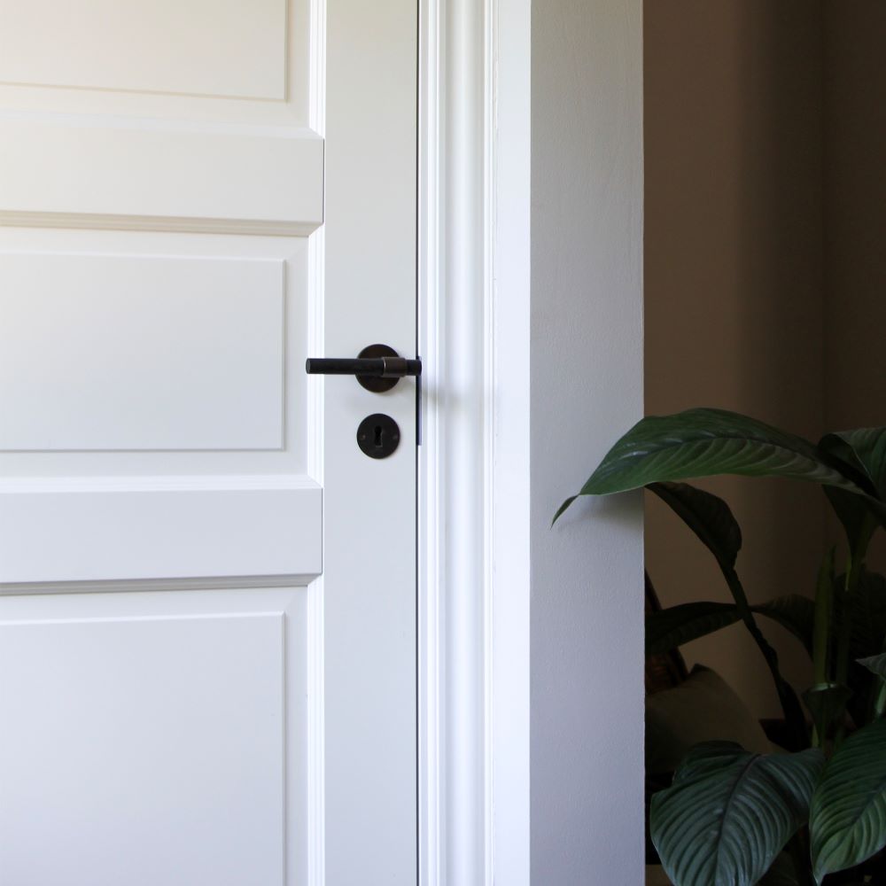 SIGNATURE door handle in Burnished Brass/Wenge. Modern door hardware made of solid brass by BRANDT Collective.