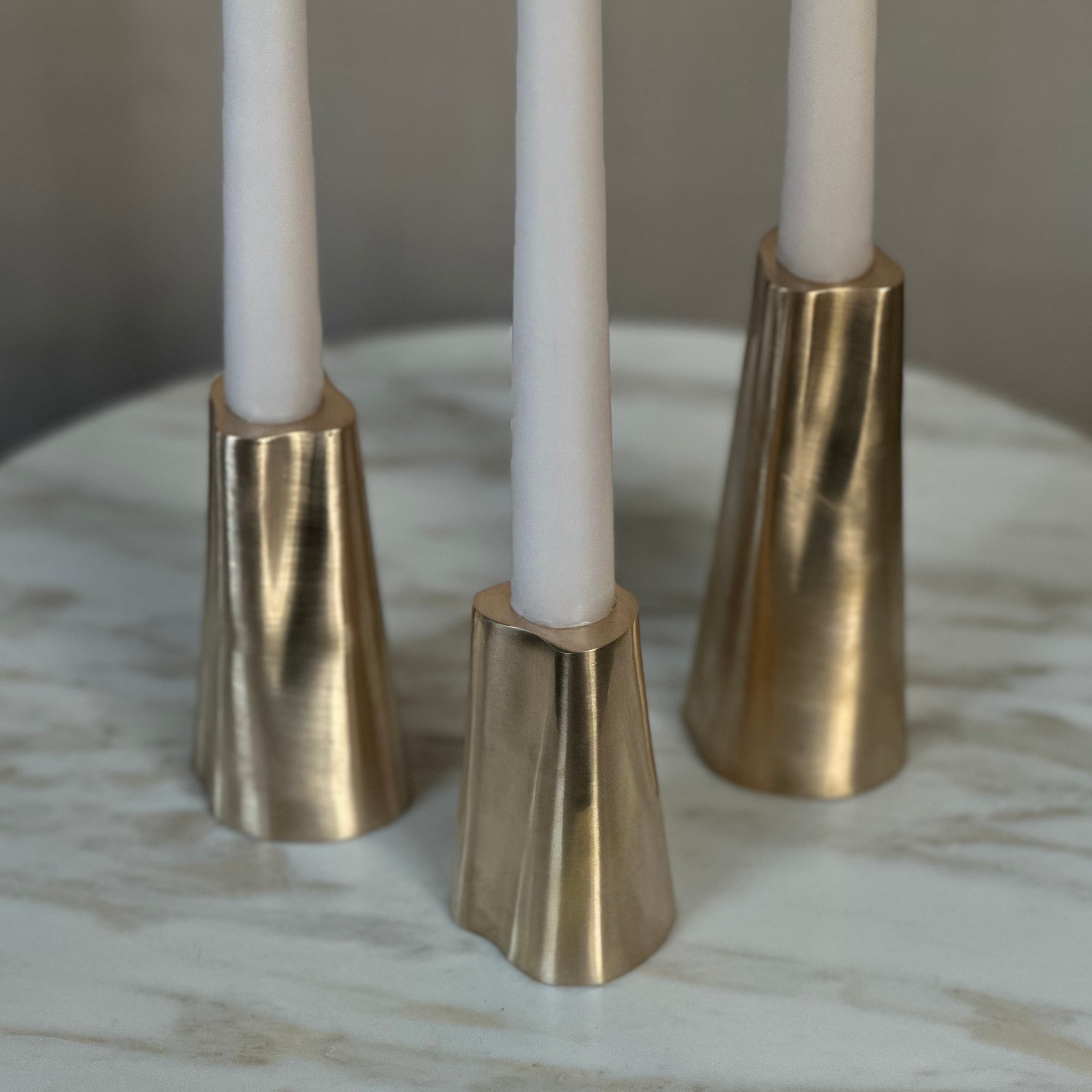 TRUNK candleholder in satin brass. Designed by Julie Brandt for BRANDT Collective